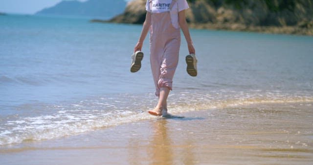 Barefoot walk along a sandy beach shore