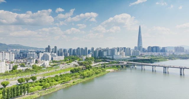 Modern city skyline with a river and bridge