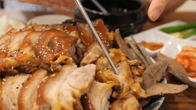 Person enjoying a meal of braised pig's feet