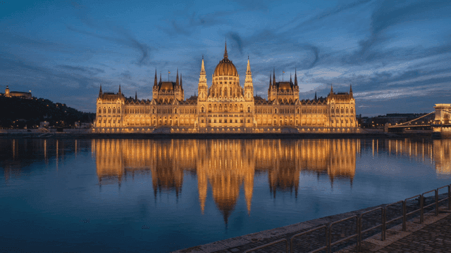 Illuminated historic building by the river