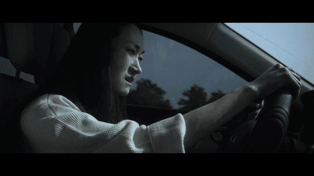 Woman crying while driving
