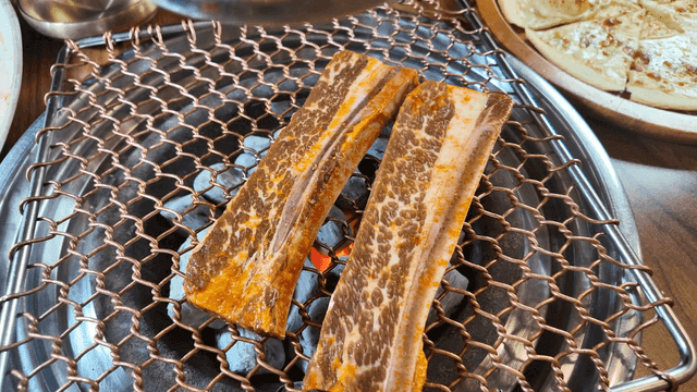 Beef short ribs grilled over charcoal