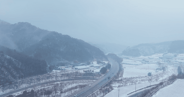 Snow-covered mountains and winding road