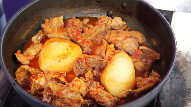 Spicy braised chicken simmering in a pot