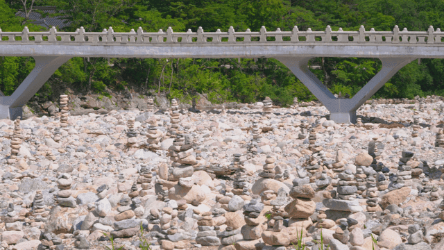 Stone towers stacked before neat stone bridge