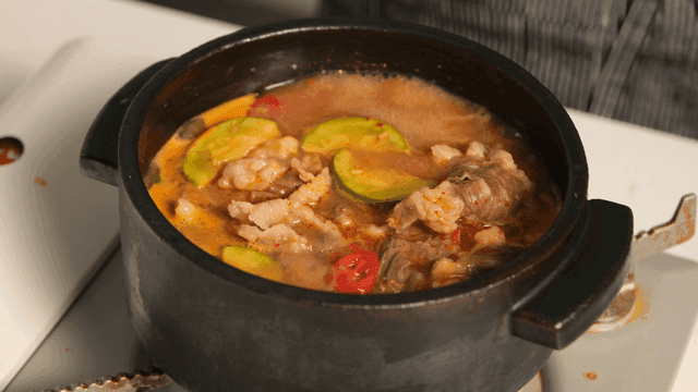 Beef soybean paste stew topped with simmering chadolbagi in pot