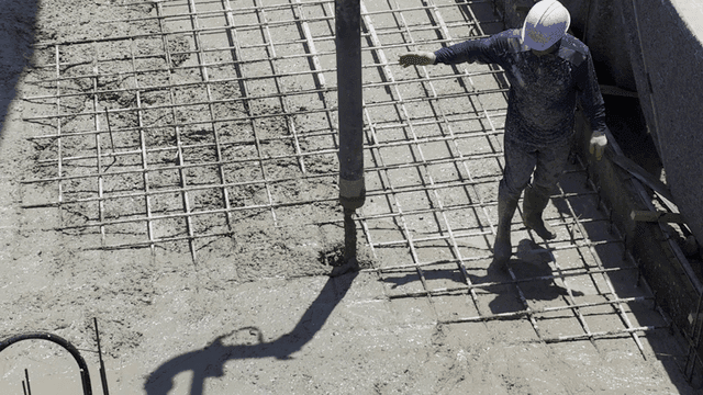Construction workers pouring concrete