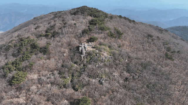 Mountain with scattered winter trees and rocks