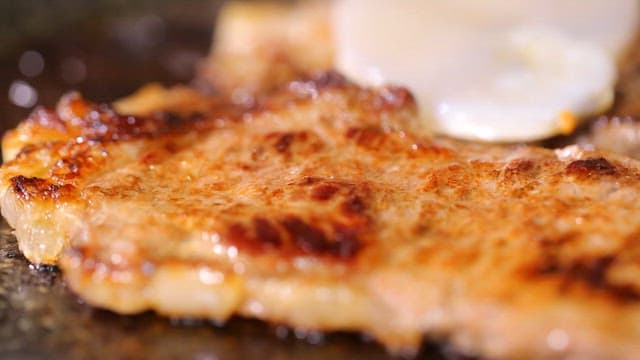 Scallop slices on top of sizzling beef