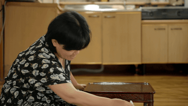 Woman cleaning a small table in the kitchen