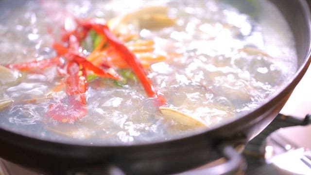 채소 고명과 함께 끓는 시원한 바지락탕