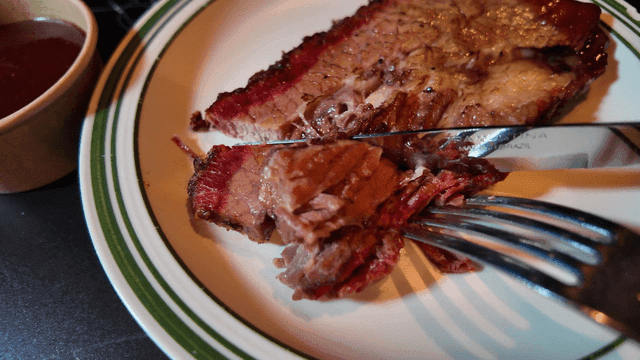 Juicy steak being sliced on a plate
