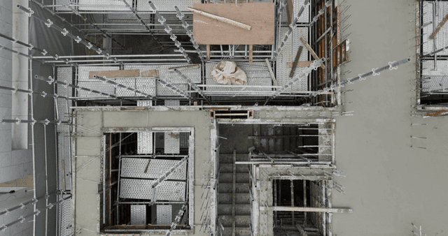 Construction site with scaffolding and worker