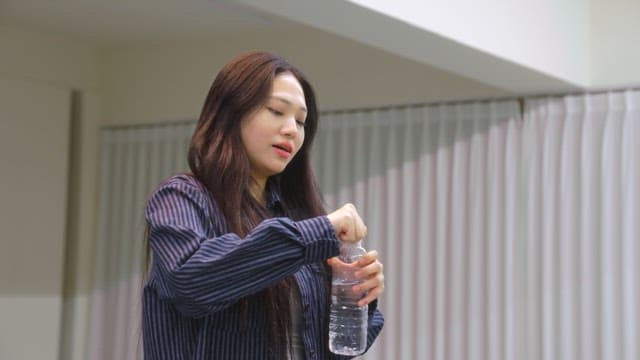 실내에서 물을 마시는 여성