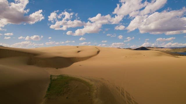 Expansive Desert Dunes Under Blue Sky