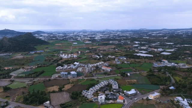Coastal village with fields and sea