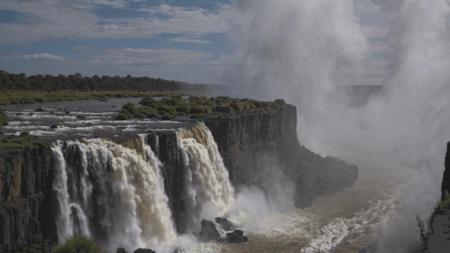 Majestic waterfall flowing along cliff.