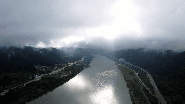 River flowing through foggy valley
