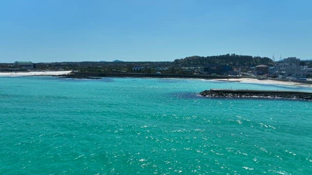 Clear turquoise sea with a distant beach