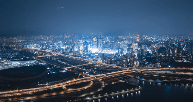 A vibrant cityscape at night with lights