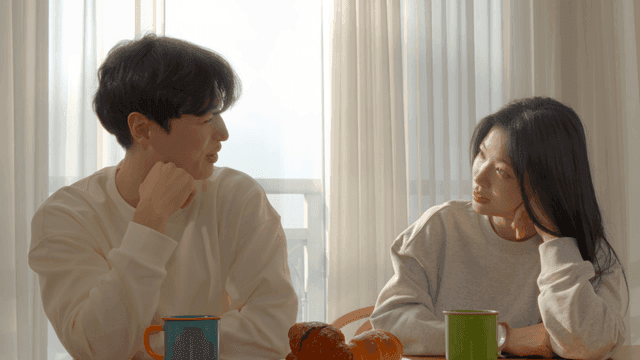 Couple talking at breakfast table in the morning light