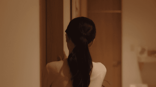 Woman standing quietly in front of door