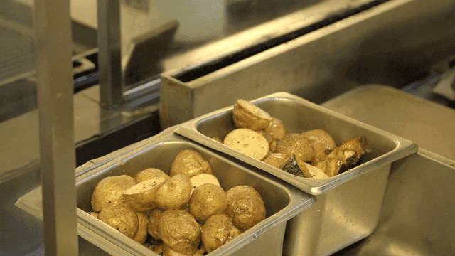 Bowl full of baked potatoes in kitchen