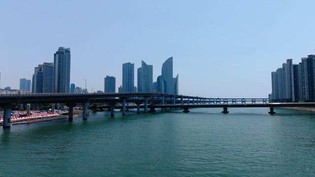 Busan cityscape with modern high-rise buildings, overpass, and the ocean