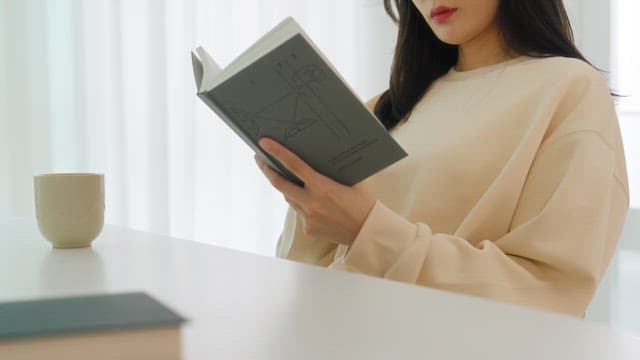 Woman Reading a Book in a Bright Room