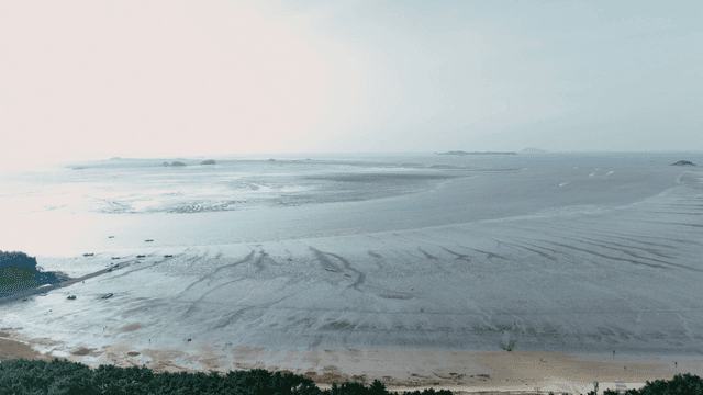 Wide mudflat with island visible in distance