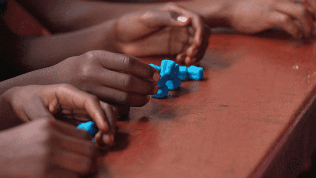 Children with blue blocks on table