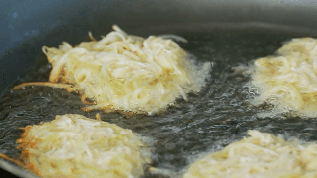 Potato pancakes frying in a pan