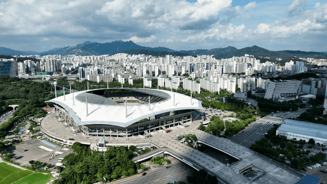 Large stadium surrounded by downtown buildings