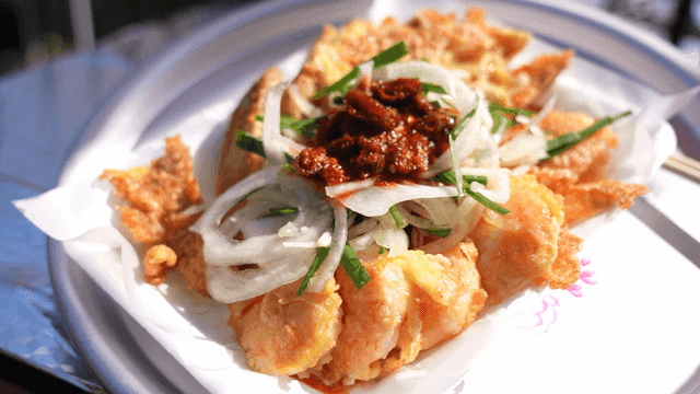 Pancake topped with onions and sauce