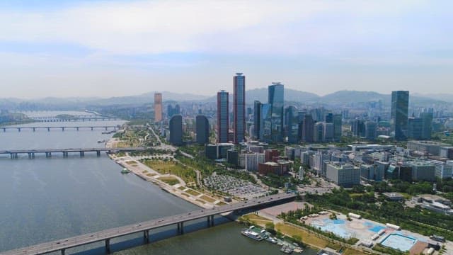 Riverside Cityscape with Buildings and Parks