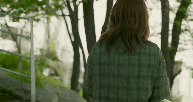Woman following man carrying box down stairs