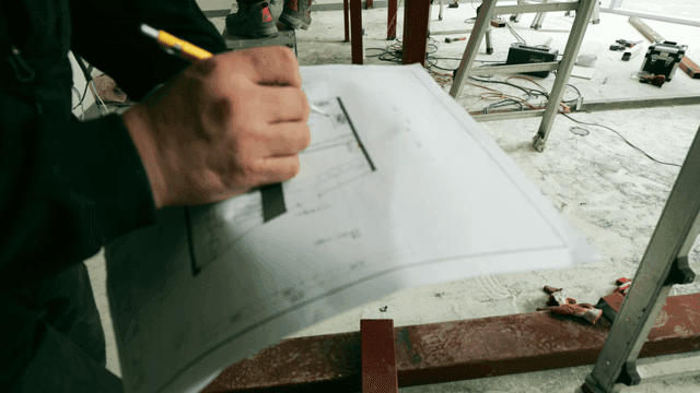 Construction site workers reviewing plans