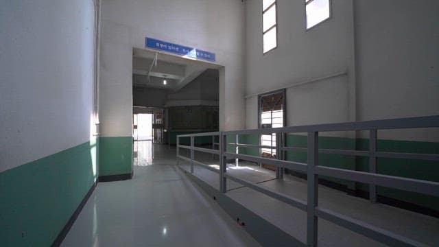 Prison Hallway with Barred Windows