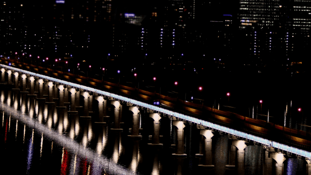 Bridges shining brightly in city at night