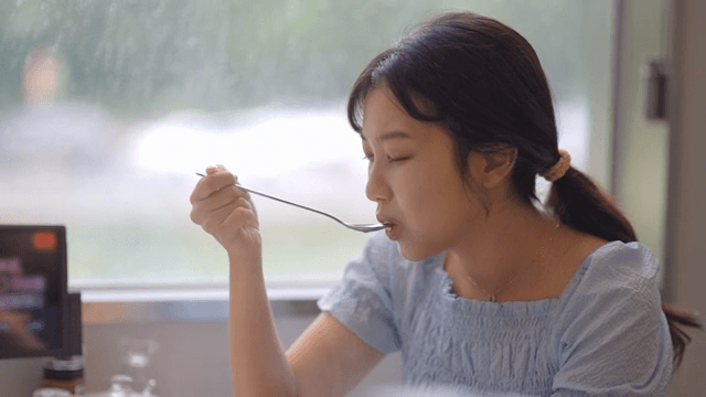 Woman enjoying a hot meal at a restaurant