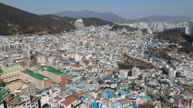 Colorful hillside village with mountains