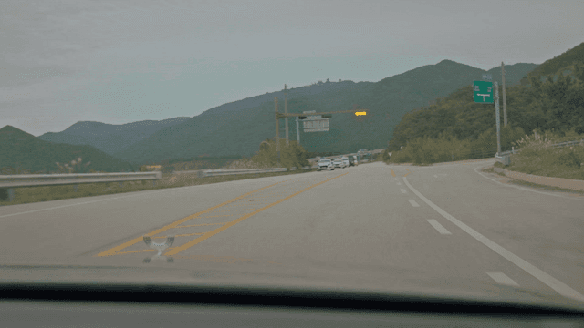 Police car passing on a winding road across