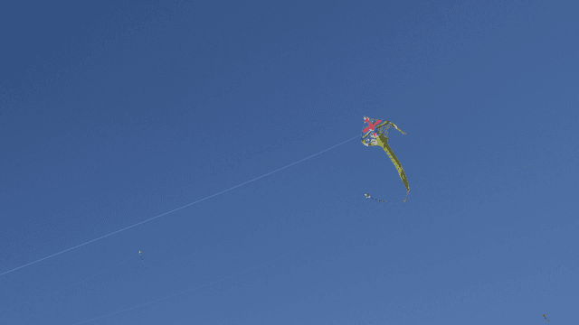 Colorful kite flying in the clear blue sky