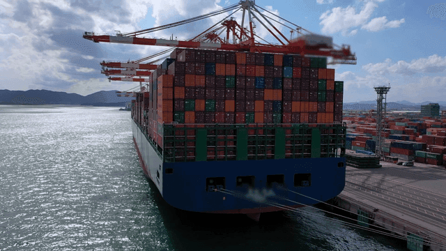Large cargo ship docked at busy port