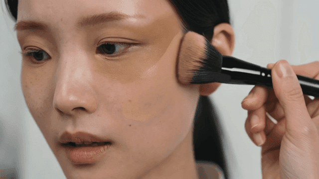 Woman applying foundation with brush