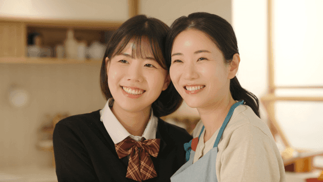 Smiling mother and daughter at home