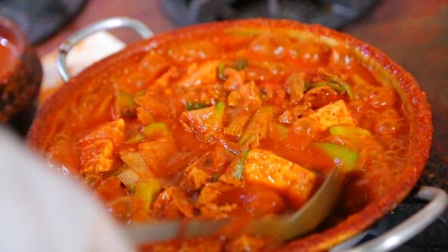 Spicy pork stew boiling in a pot