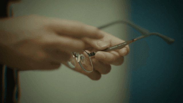 Person holding a pair of glasses