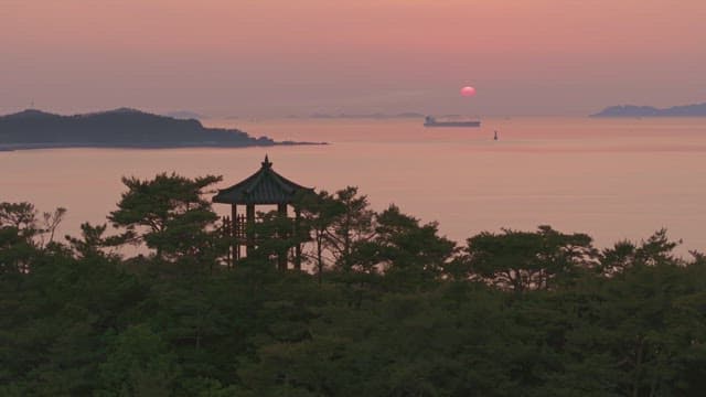 Serene sunset over the sea with a old pavilion