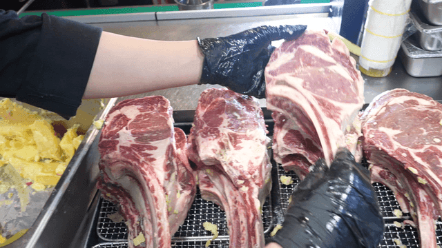 Aged raw tomahawk steak, carefully prepared